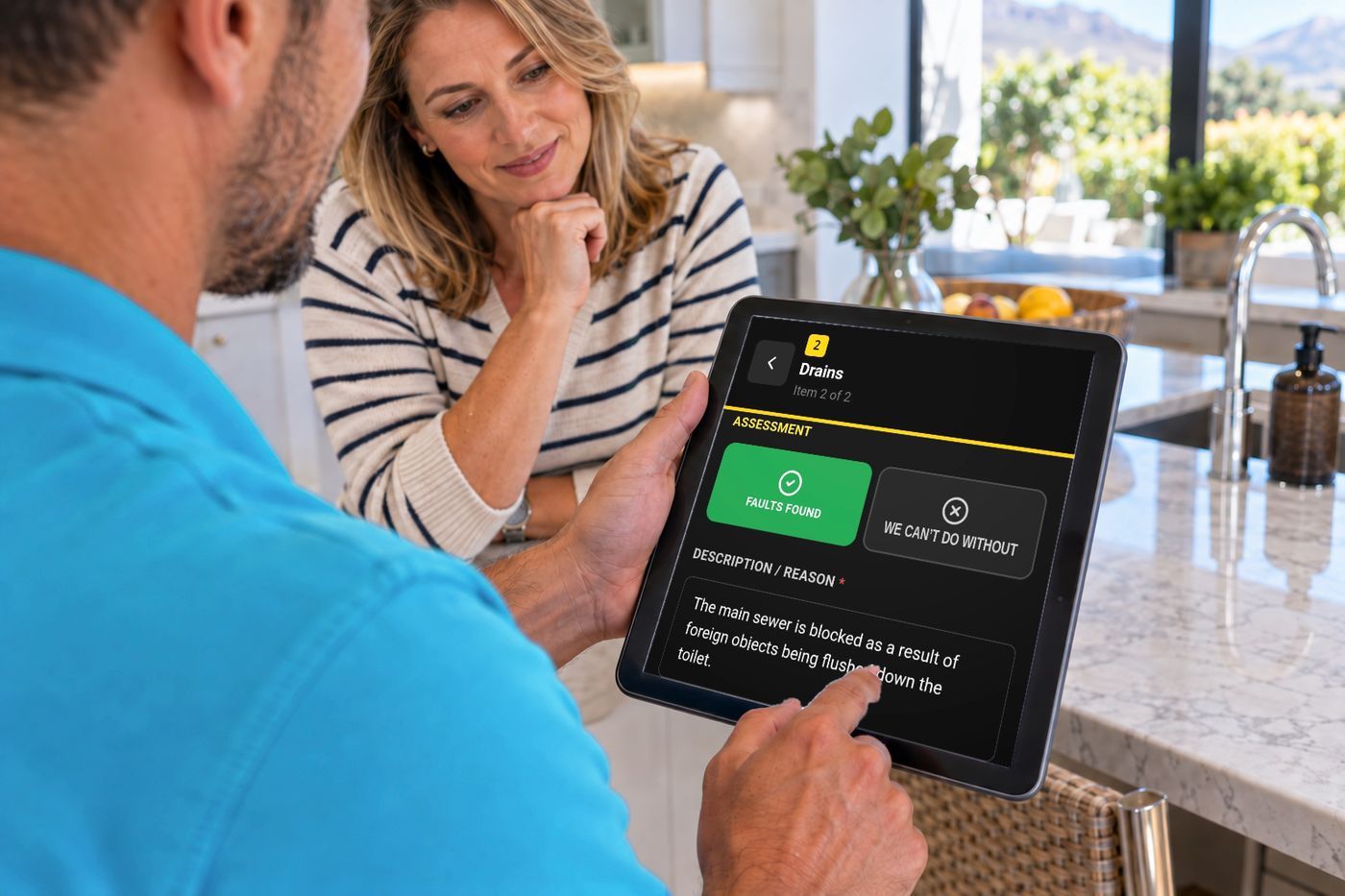 Technician showing a homeowner the job assessment recorded on site in our own app